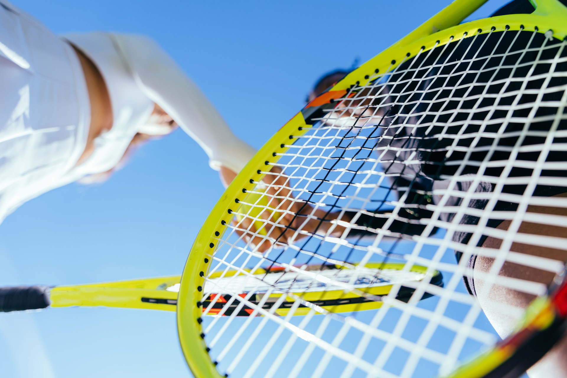 Tennis players sharing a handshake from a low angle on the court